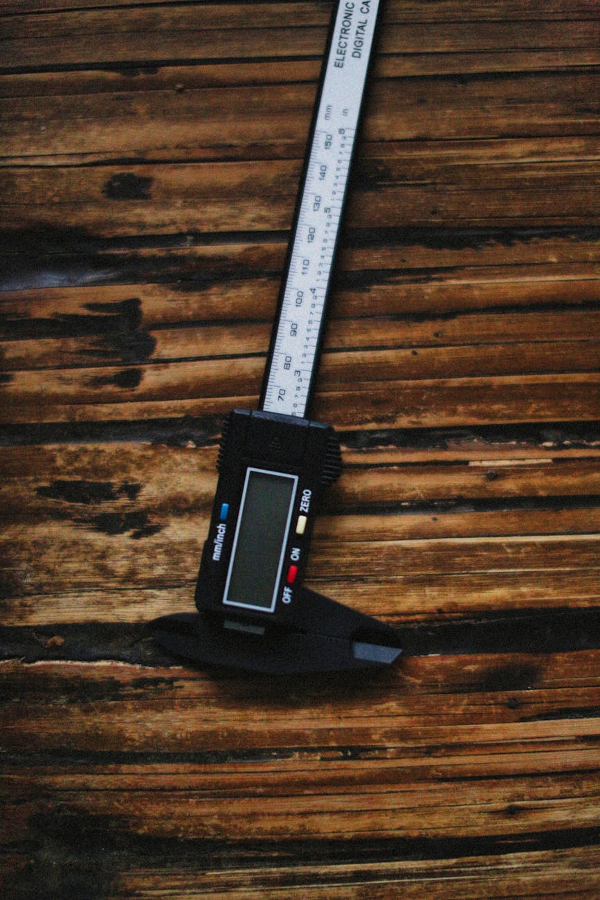 Digital caliper on wooden surface for measuring blade length